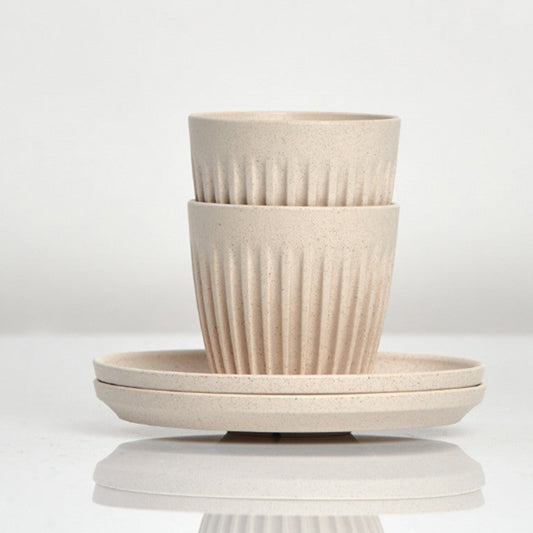 Set of 2 small 3oz HuskeeOriginal reusable espresso cups with saucers featuring the signature vertical ribbed design made from organic coffee husk waste in natural.