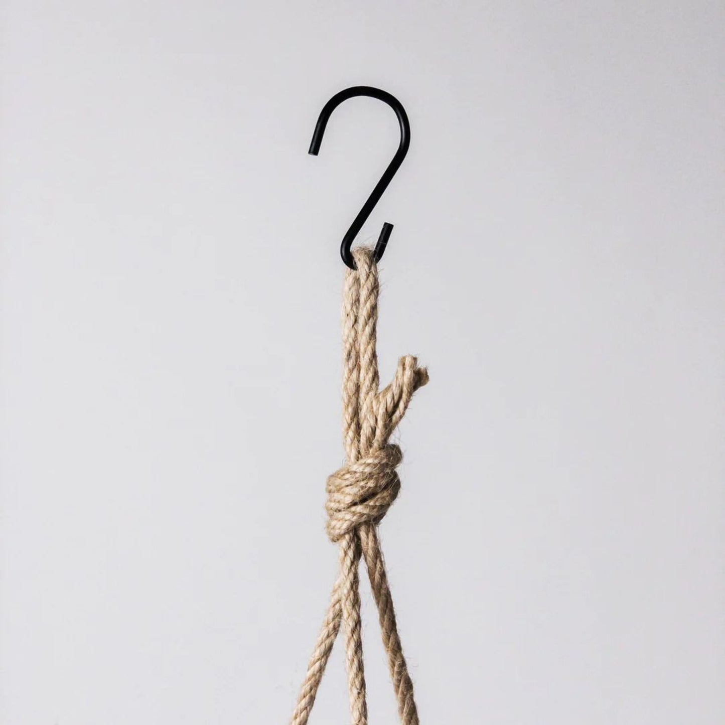 Potted hanging mechanism showing fine woven hemp rope and metal S hook on a clean white background.