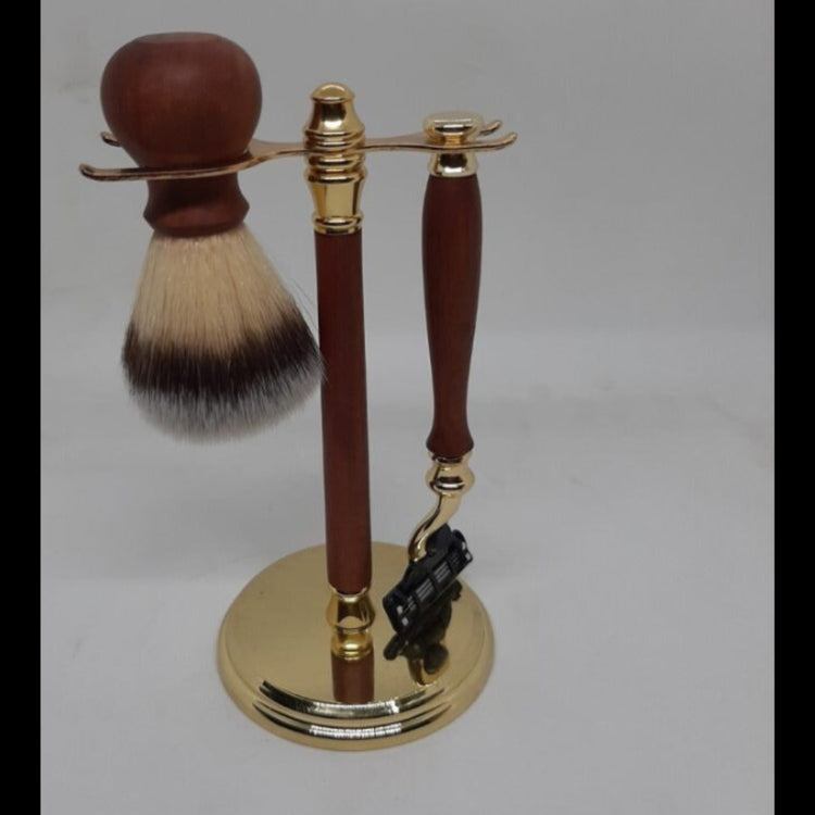 A premium 3-piece men's grooming kit featuring a hand-turned recycled timber Gillette Mach III razor and matching shave brush resting on a wooden shaft stand, handcrafted in Australia in gold.