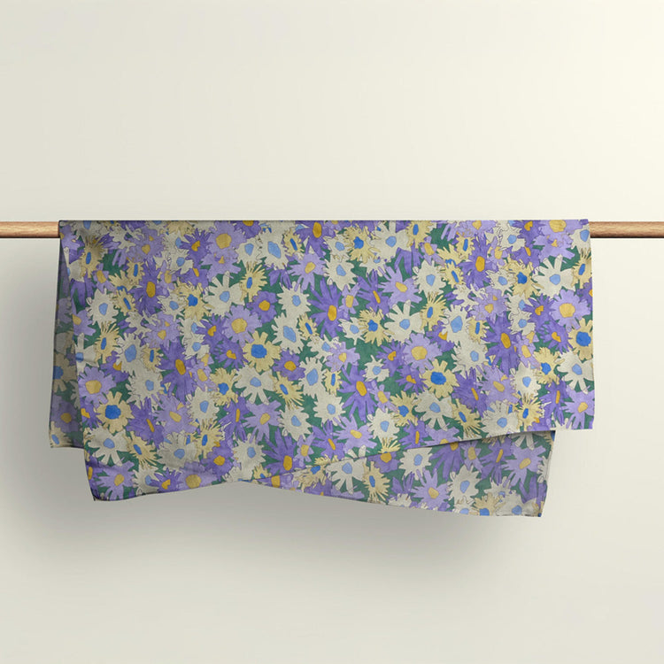 The Field of Dreams floral fabric wrap pattern draped over a wooden rod to showcase the premium deadstock material.