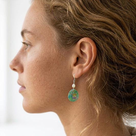 On-model shot showcasing the fit and length of the upcycled green nebula statement dangle earrings with white pearls, styled in Australia.