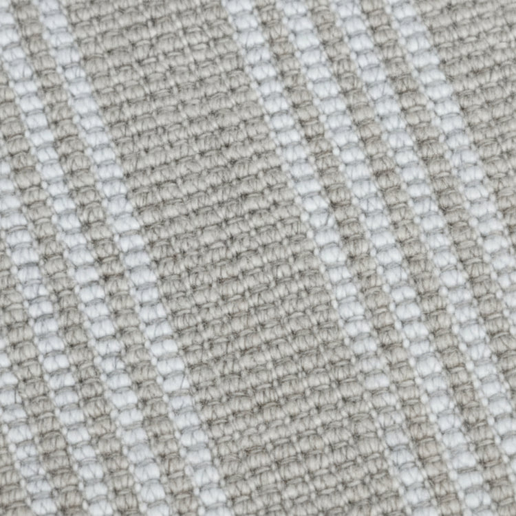 Close-up texture detail of the natural and white stripe woven yarn on a Zebra Home Franklin washable floor rug.
