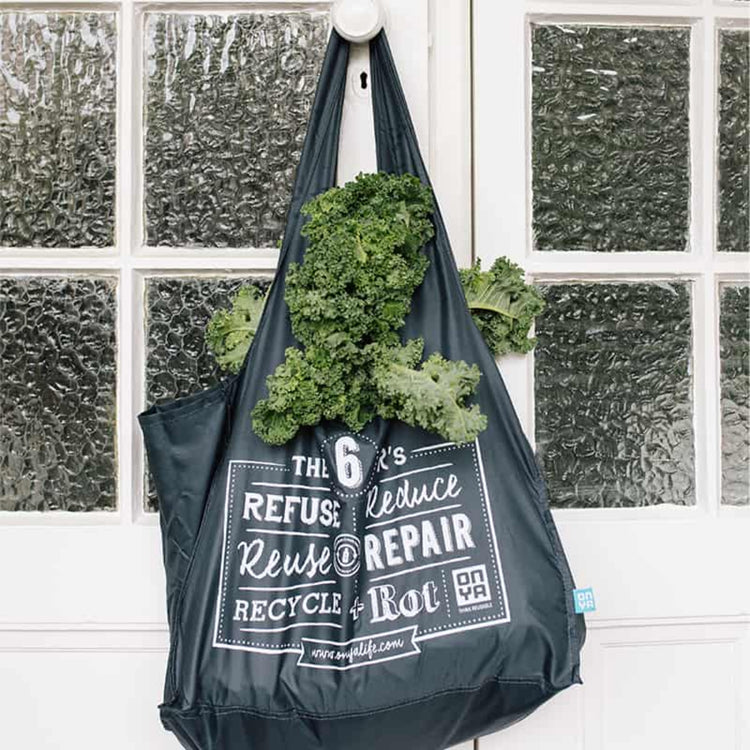 Onya heavy duty reusable shopping tote bag with an extra wide gusset and 10kg capacity hanging on a door holdiing groceries, available in Australia.