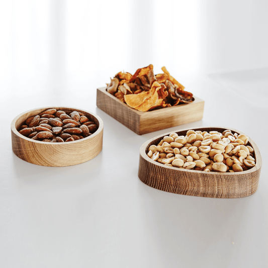 A minimalist LIND DNA oiled oak wood storage box styled on a kitchen dining table as a versatile decor accessory.