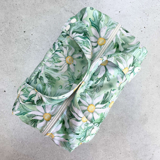 Detailed close up view of the durable woven bag securely zipped on a kitchen benchtop in flannel flower.