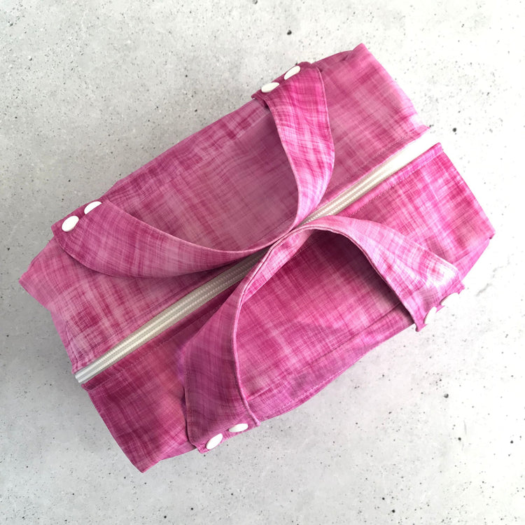 Top down view od a single Produce Pod reusable veggie storage bag featuring a custom Rhubarb print.