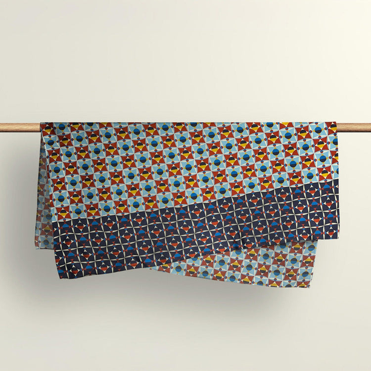 The Shapeshifter abstract pattern fabric wrap draped over a wooden rod to show the premium deadstock material texture.