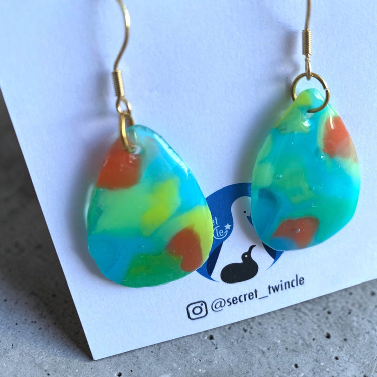 Side view of the clear blue recycled plastic drop dangle earrings, perfect as a sustainable fashion gift.