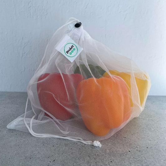 See through recycled mesh grocery bag holding capsicum for quick scanning at the supermarket checkout.