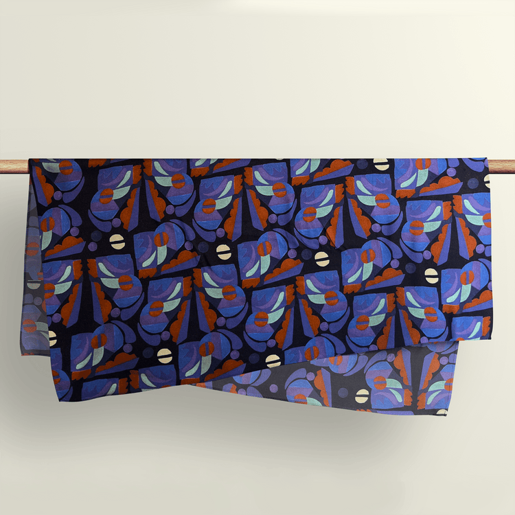 The Tribal Beats pattern fabric wrap draped over a wooden rod to show the premium deadstock material texture.