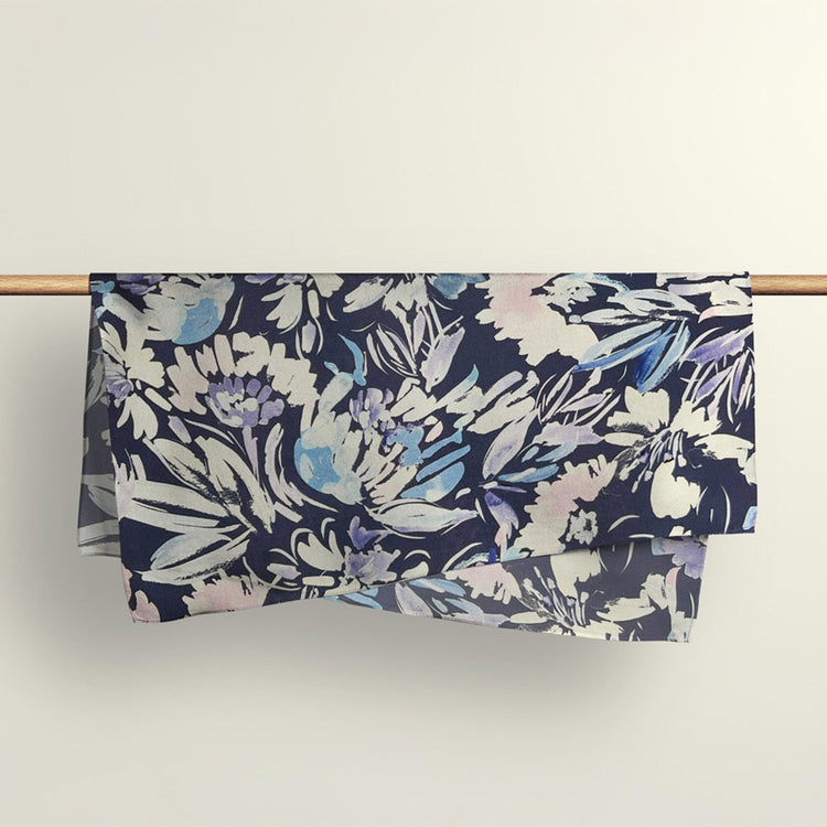 The Wildflowers floral fabric wrap draped over a wooden rod to show the premium deadstock material texture.