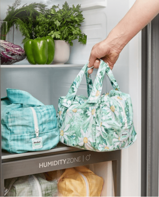 Produce pods stored in a refrigerator drawer keeping herbs and vegetables fresh.