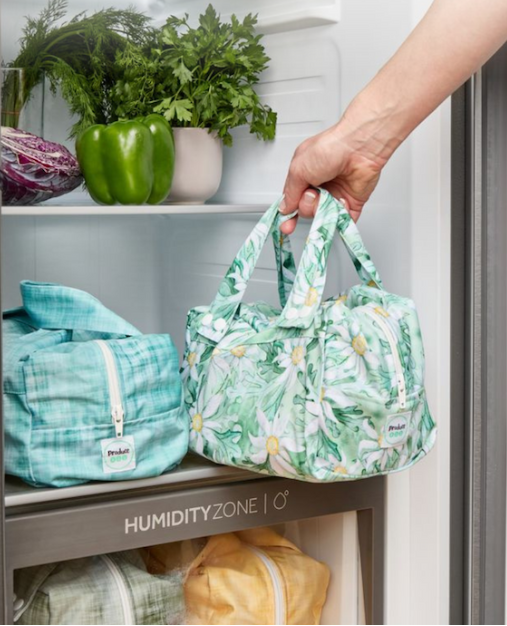 Produce pods stored in a refrigerator drawer keeping herbs and vegetables fresh.