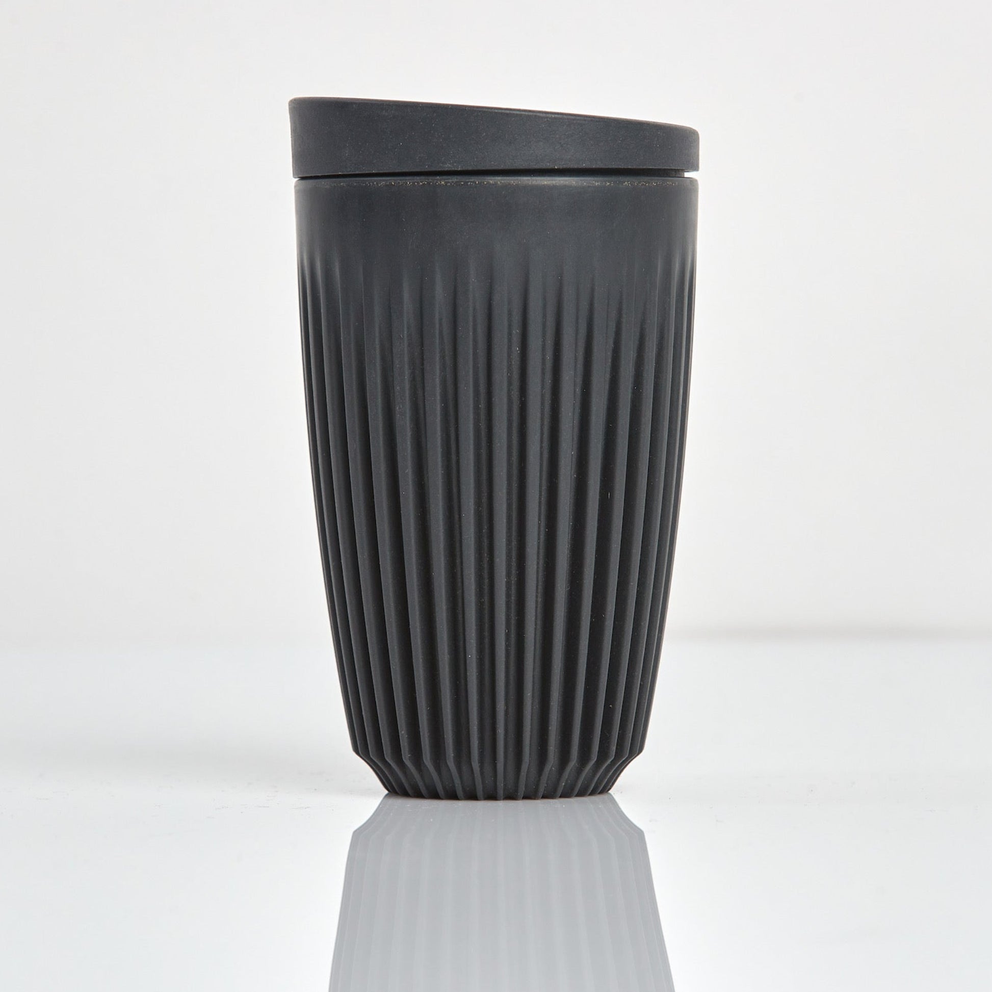 Large 12oz HuskeeOriginal reusable coffee cup featuring the signature vertical ribbed design made from sustainable coffee husk wastein charcoal.