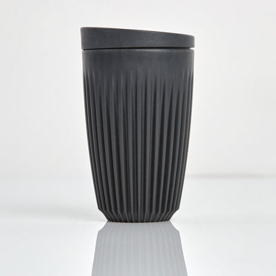 Large 12oz HuskeeOriginal reusable coffee cup featuring the signature vertical ribbed design made from sustainable coffee husk wastein charcoal.