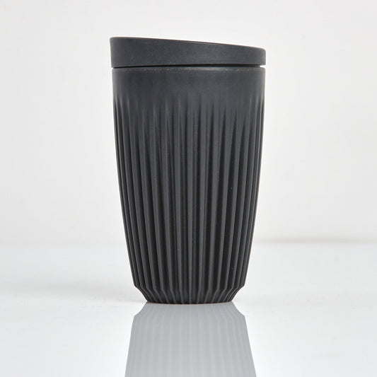 Large 12oz HuskeeOriginal reusable coffee cup featuring the signature vertical ribbed design made from sustainable coffee husk wastein charcoal.