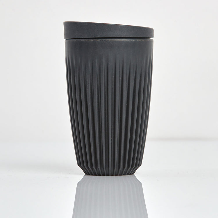 Large 12oz HuskeeOriginal reusable coffee cup featuring the signature vertical ribbed design made from sustainable coffee husk wastein charcoal.