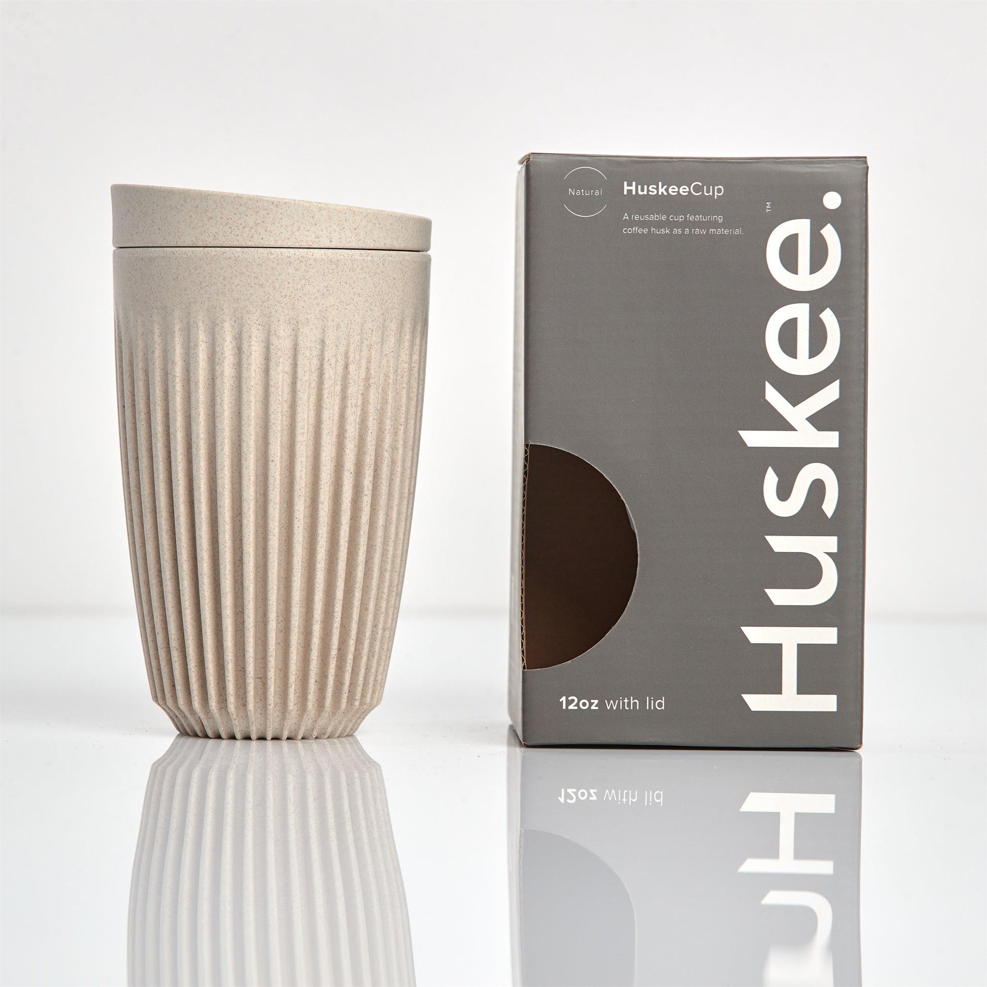 Large 12oz HuskeeOriginal reusable coffee cup featuring the signature vertical ribbed design made from sustainable coffee husk waste in natural with box.