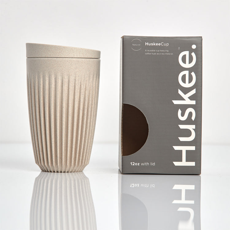 Large 12oz HuskeeOriginal reusable coffee cup featuring the signature vertical ribbed design made from sustainable coffee husk waste in natural with box.