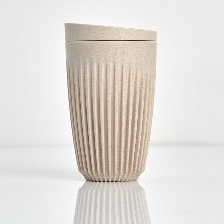 Large 12oz HuskeeOriginal reusable coffee cup featuring the signature vertical ribbed design made from sustainable coffee husk waste in natural.