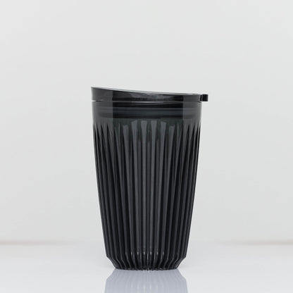 Large 12oz HuskeeRenew translucent reusable coffee cup featuring the signature vertical ribbed design made from high-performance recycled polymer in smoke.