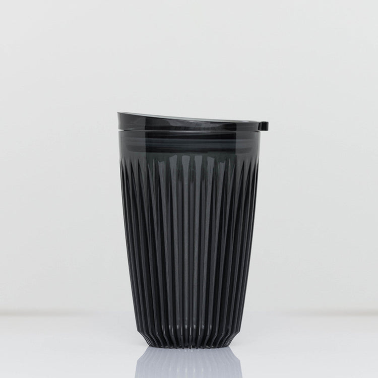 Large 12oz HuskeeRenew translucent reusable coffee cup featuring the signature vertical ribbed design made from high-performance recycled polymer in smoke.