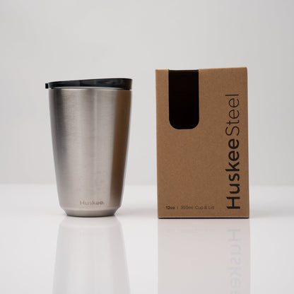 Large 12oz HuskeeSteel reusable coffee cup with matching stopper lid made from 91% recycled vacuum insulated stainless steel in steel with box.