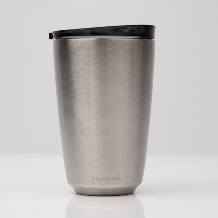 Large 12oz HuskeeSteel reusable coffee cup with matching stopper lid made from 91% recycled vacuum insulated stainless steel in steel.