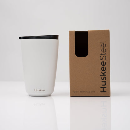 Large 12oz HuskeeSteel reusable coffee cup with matching stopper lid made from 91% recycled vacuum insulated stainless steel in white with box.