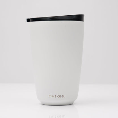 Large 12oz HuskeeSteel reusable coffee cup with matching stopper lid made from 91% recycled vacuum insulated stainless steel in white.