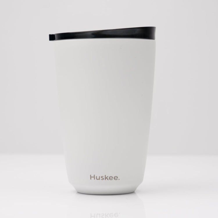 Large 12oz HuskeeSteel reusable coffee cup with matching stopper lid made from 91% recycled vacuum insulated stainless steel in white.