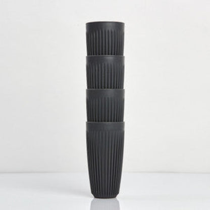 Extra large 16oz HuskeeOriginal reusable coffee cup featuring the signature vertical ribbed design made from sustainable coffee husk waste in charcoal 4 pack.