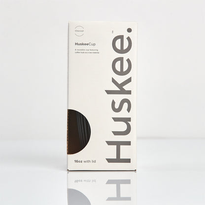 Extra large 16oz HuskeeOriginal reusable coffee cup featuring the signature vertical ribbed design made from sustainable coffee husk waste in charcoal in box.