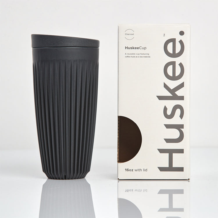 Extra large 16oz HuskeeOriginal reusable coffee cup featuring the signature vertical ribbed design made from sustainable coffee husk waste in charcoal with box.