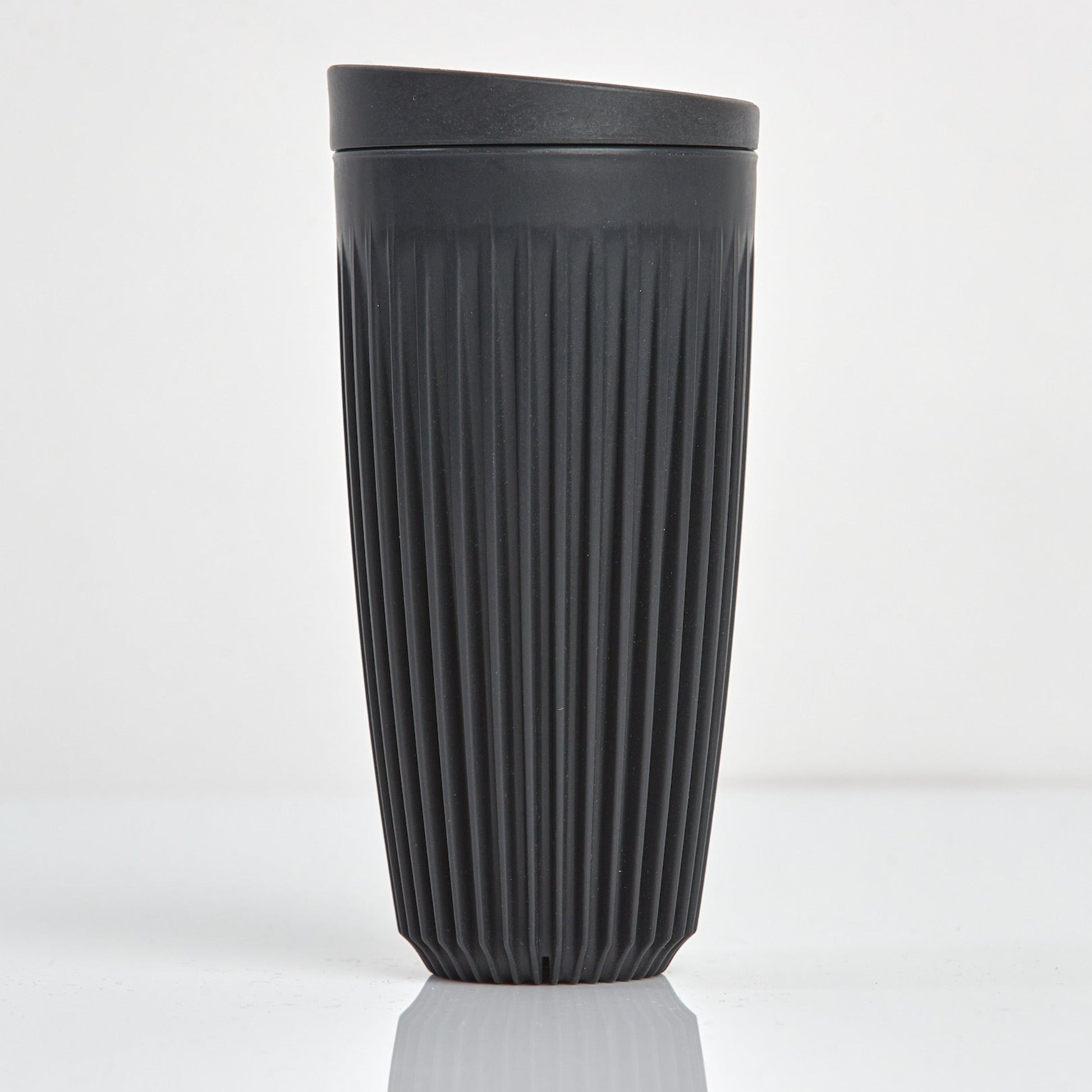 Extra large 16oz HuskeeOriginal reusable coffee cup featuring the signature vertical ribbed design made from sustainable coffee husk waste in charcoal.