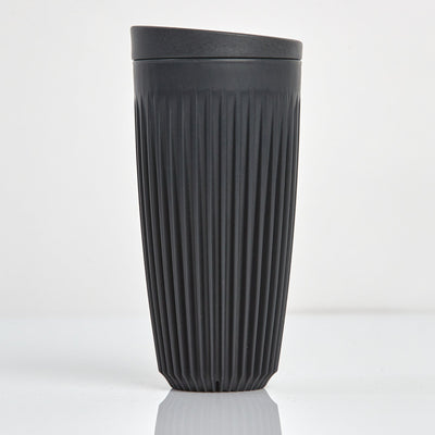 Extra large 16oz HuskeeOriginal reusable coffee cup featuring the signature vertical ribbed design made from sustainable coffee husk waste in charcoal.