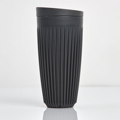 Extra large 16oz HuskeeOriginal reusable coffee cup featuring the signature vertical ribbed design made from sustainable coffee husk waste in charcoal.