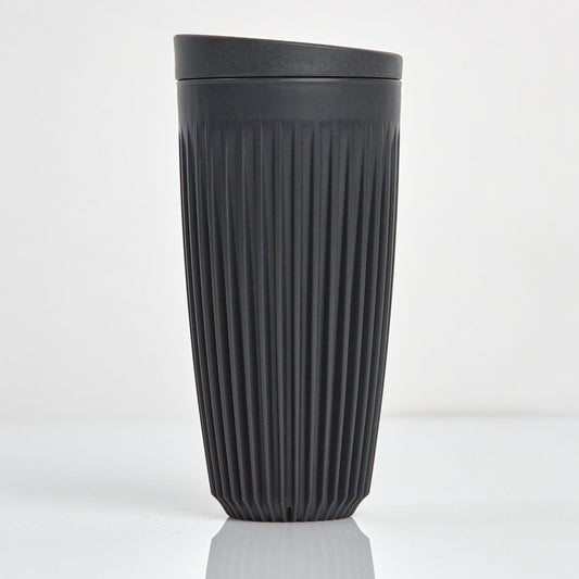 Extra large 16oz HuskeeOriginal reusable coffee cup featuring the signature vertical ribbed design made from sustainable coffee husk waste in charcoal.