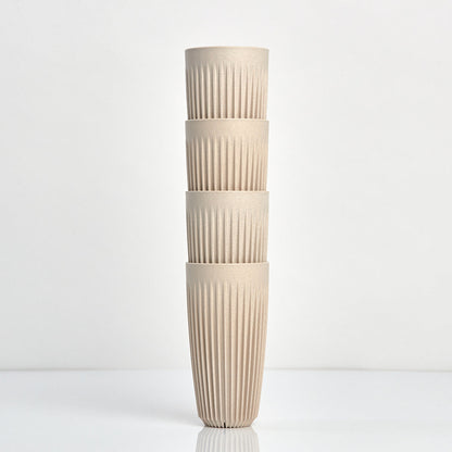 Extra large 16oz HuskeeOriginal reusable coffee cup featuring the signature vertical ribbed design made from sustainable coffee husk waste in natural 4 pack.