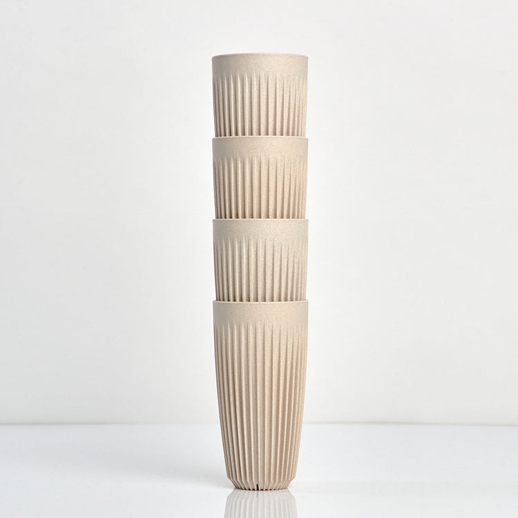 Extra large 16oz HuskeeOriginal reusable coffee cup featuring the signature vertical ribbed design made from sustainable coffee husk waste in natural 4 pack.