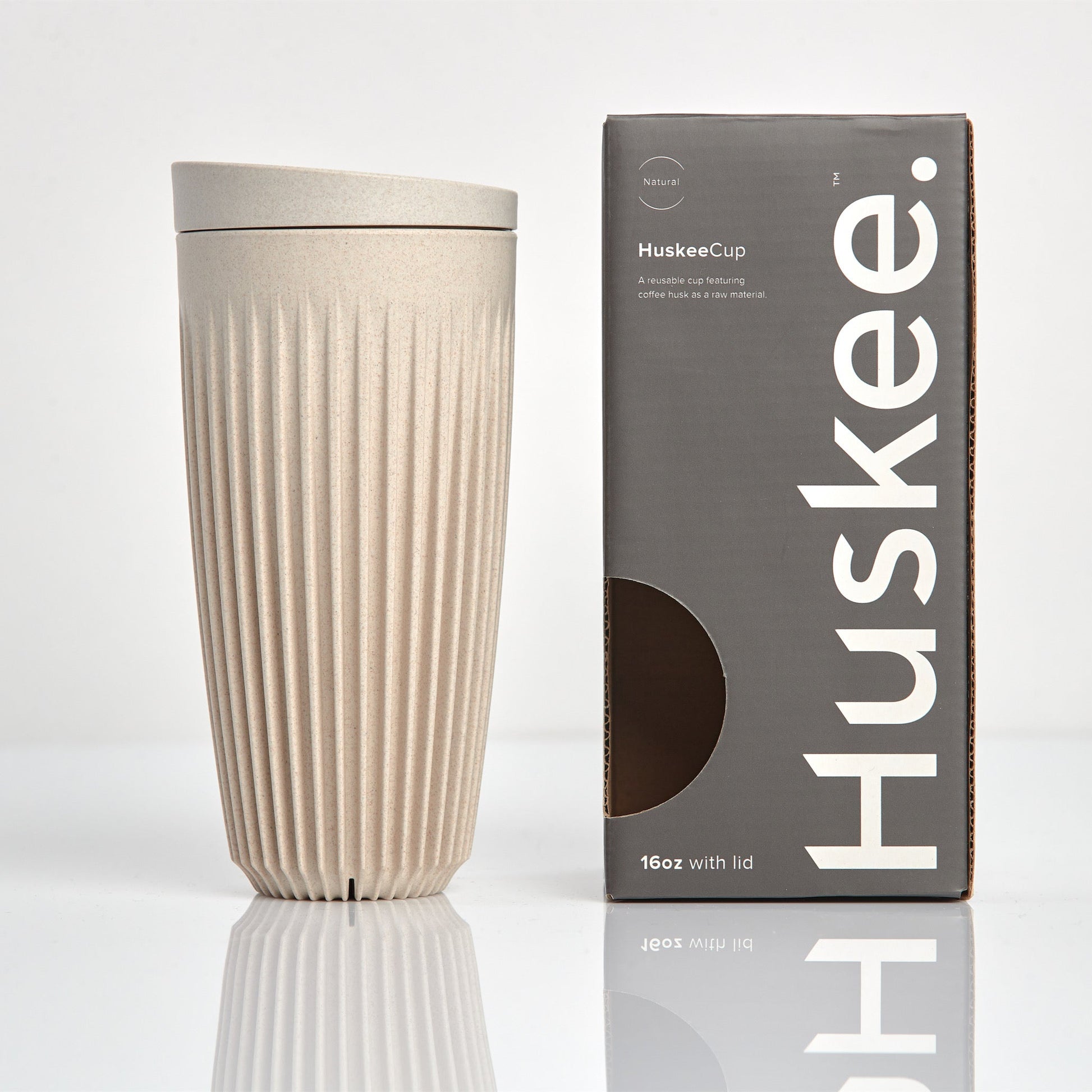 Extra large 16oz HuskeeOriginal reusable coffee cup featuring the signature vertical ribbed design made from sustainable coffee husk waste in natural with box.