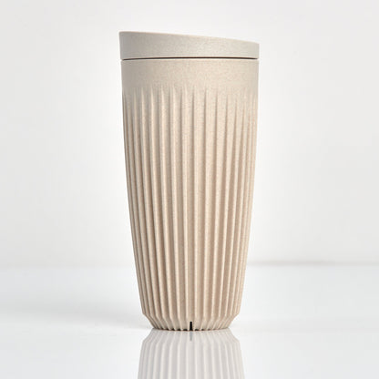 Extra large 16oz HuskeeOriginal reusable coffee cup featuring the signature vertical ribbed design made from sustainable coffee husk waste in natural.