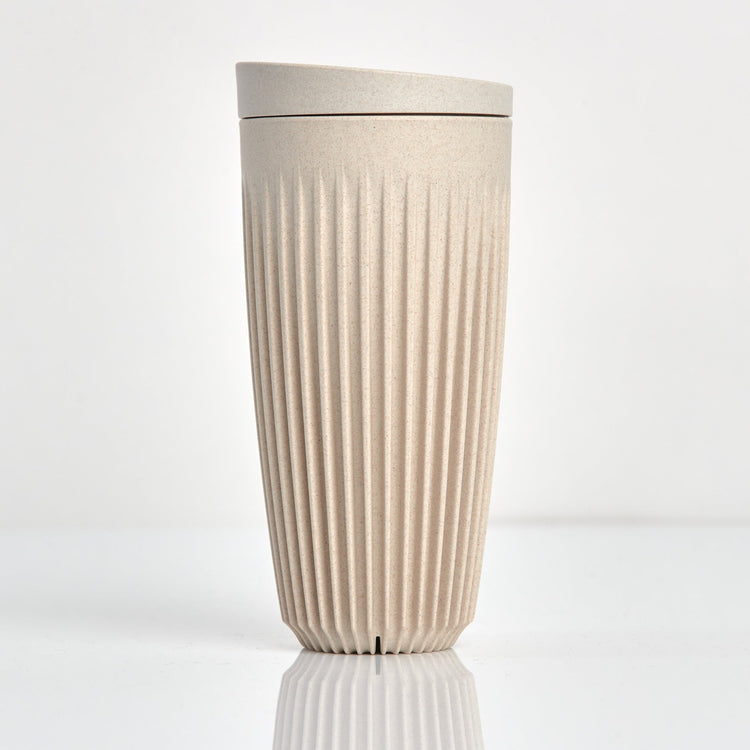 Extra large 16oz HuskeeOriginal reusable coffee cup featuring the signature vertical ribbed design made from sustainable coffee husk waste in natural.