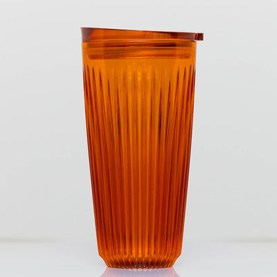 Extra large 16oz HuskeeRenew translucent reusable coffee cup featuring the signature vertical ribbed design made from high-performance recycled polymer in amber.