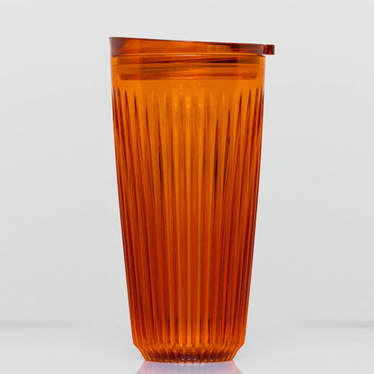 Extra large 16oz HuskeeRenew translucent reusable coffee cup featuring the signature vertical ribbed design made from high-performance recycled polymer in amber.