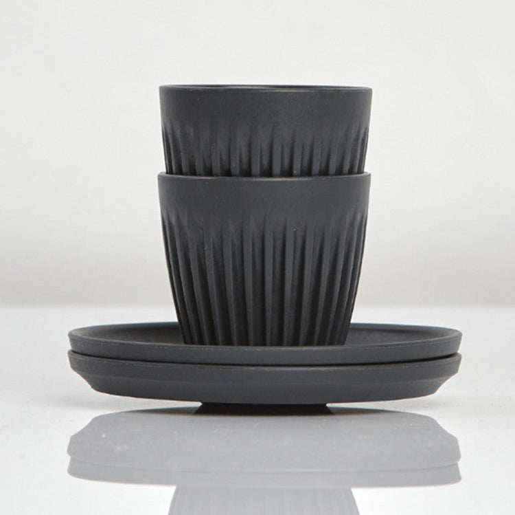 Set of 2 small 3oz HuskeeOriginal reusable espresso cups with saucers featuring the signature vertical ribbed design made from organic coffee husk waste in charcoal.