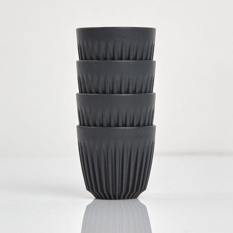 Set of 4 small 3oz HuskeeOriginal reusable espresso cups without saucers featuring the signature vertical ribbed design made from organic coffee husk waste in charcoal.