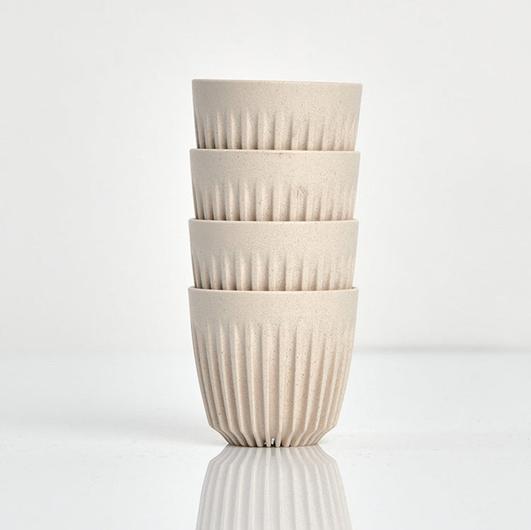Set of 4 small 3oz HuskeeOriginal reusable espresso cups without saucers featuring the signature vertical ribbed design made from organic coffee husk waste in natural.