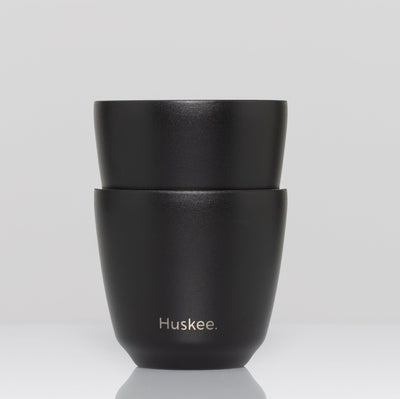 Set of 2 HuskeeSteel 3oz espresso cups crafted from 91% recycled double-wall vacuum insulated stainless steel in black.