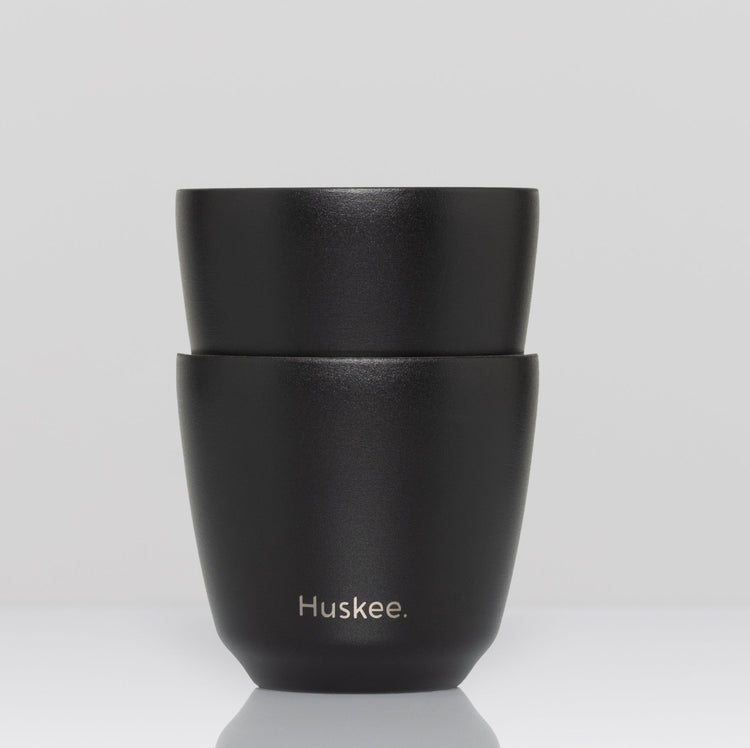 Set of 2 HuskeeSteel 3oz espresso cups crafted from 91% recycled double-wall vacuum insulated stainless steel in black.